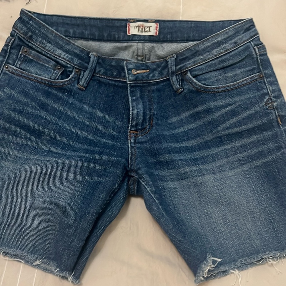 Tilt denim shorts with brown stitching on the back pockets